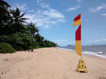 Lifeguard hut on beach against sky