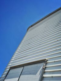 Low angle view of building against clear blue sky