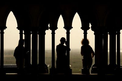 Silhouette people standing in historic building