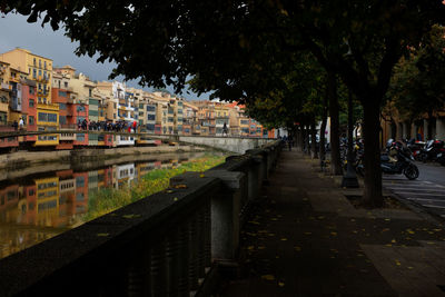 View of footpath by canal in city