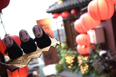 Close-up of illuminated lanterns hanging outdoors