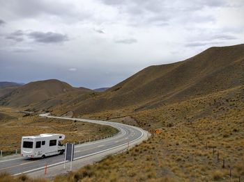 Scenic view of mountains against cloudy sky