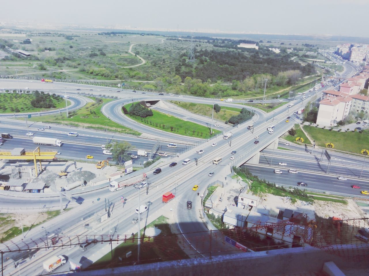 transportation, high angle view, road, aerial view, mode of transport, landscape, road marking, car, land vehicle, highway, built structure, travel, mountain, architecture, day, connection, outdoors, bridge - man made structure, city, tree
