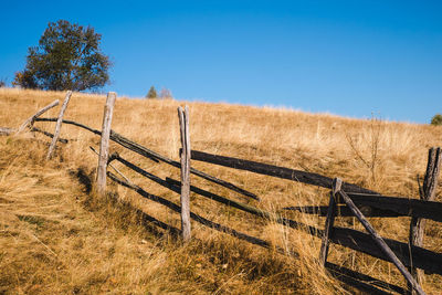 Fence on field against sky