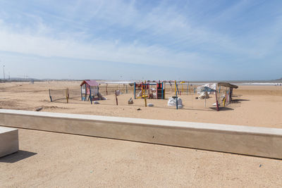 People at beach against sky