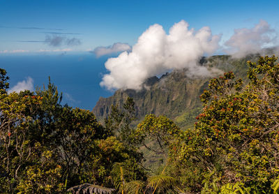 Fluted rocks of the na pali mountains with clouds forming  from kalalau lookout on kauai