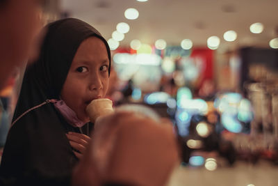 Portrait of young woman drinking ice cream
