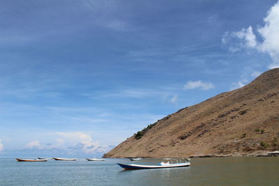Boat moored on sea against sky