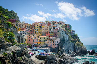 Cinque terre by sea against sky