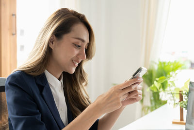 Young woman using mobile phone