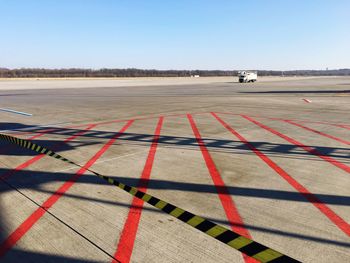 Empty airport runway against sky