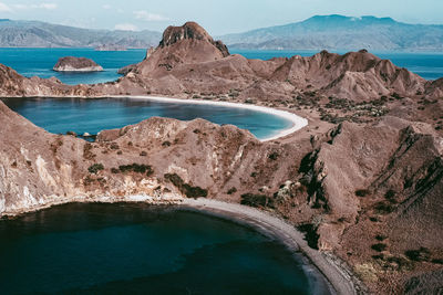 Scenic view of sea and mountains against sky