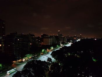 High angle view of illuminated buildings against sky at night