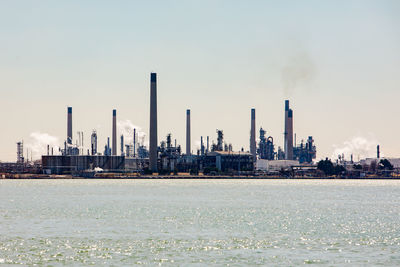 Busy lake oil refineries industrial plants daytime afternoon