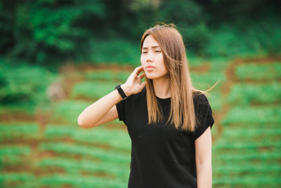 Young woman standing on agricultural field