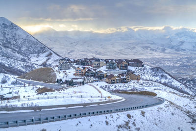 Aerial view of snow covered landscape against sky