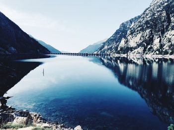 Scenic view of lake and snowcapped mountains against sky
