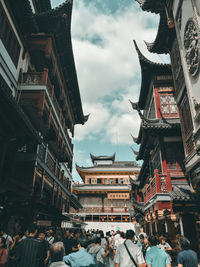 People amidst buildings in city