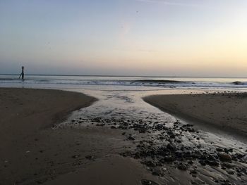 Scenic view of beach against sky during sunset