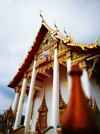 Low angle view of statue of temple against sky