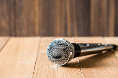 Close-up of microphone on wooden table