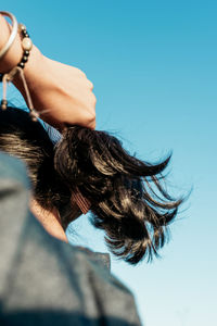 Portrait of woman against blue sky