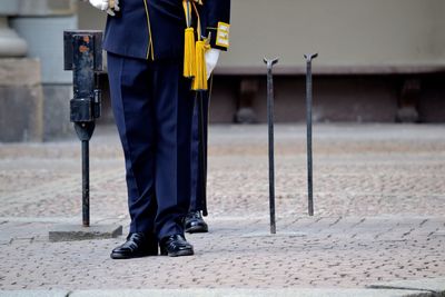 Low section of men standing in uniform on footpath