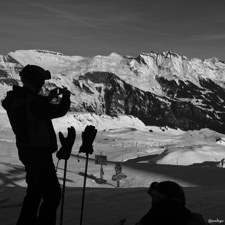 mountain, snow, winter, cold temperature, lifestyles, leisure activity, men, mountain range, scenics, tranquil scene, tranquility, nature, beauty in nature, rear view, weather, landscape, standing, season