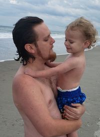 Portrait of shirtless boy at beach