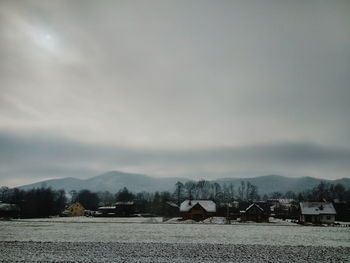 Houses and trees against sky