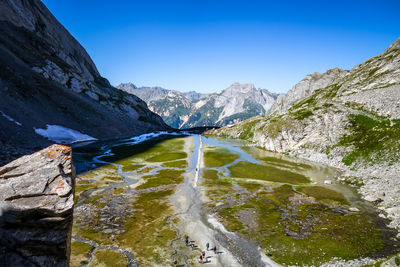 Scenic view of mountains against clear blue sky