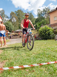 Man riding bicycle on field