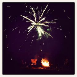 Low angle view of firework display at night