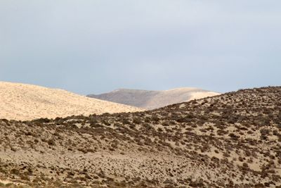 Scenic view of arid landscape against sky