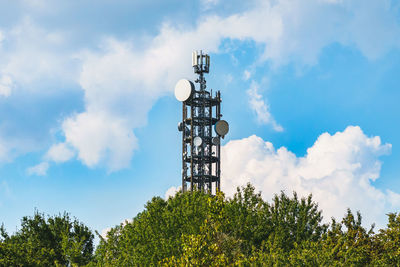 Low angle view of communications tower against sky