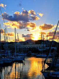 Boats in harbor at sunset