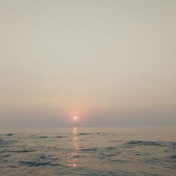 Scenic view of sea against clear sky during sunset