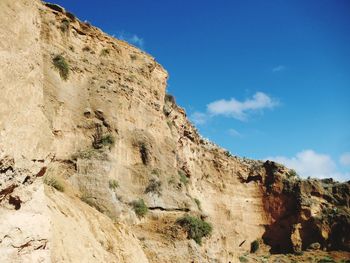 Low angle view of rock formation against sky