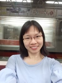 Portrait of a smiling mid adult woman in train
