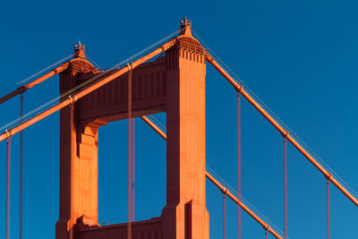 Low angle view of bridge against clear blue sky