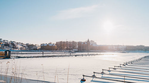 Panoramic view of city during winter against sky