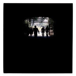 Silhouette people walking in tunnel