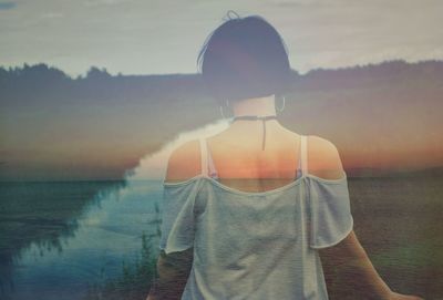 Double exposure of woman and landscape during sunset