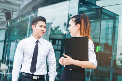 Colleagues talking in modern office