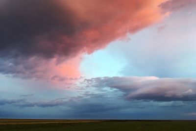 Scenic view of field against sky during sunset