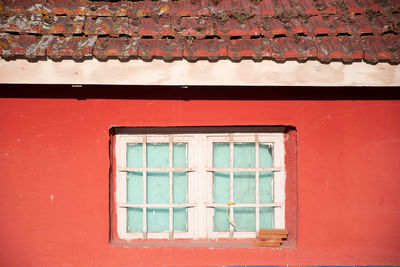 Closed window of red house