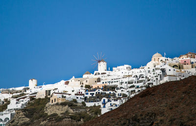 Town against clear blue sky