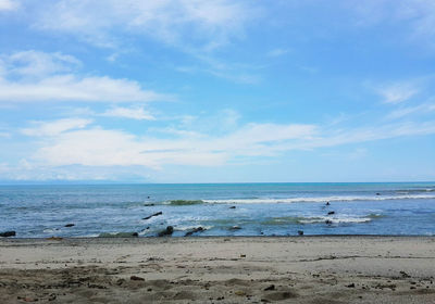 Scenic view of beach against blue sky