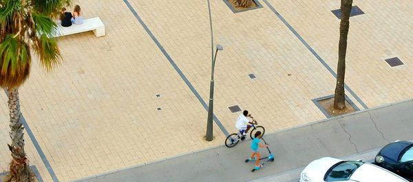 High angle view of woman riding bicycle