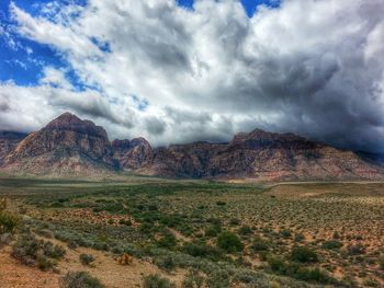 Scenic view of mountains against cloudy sky